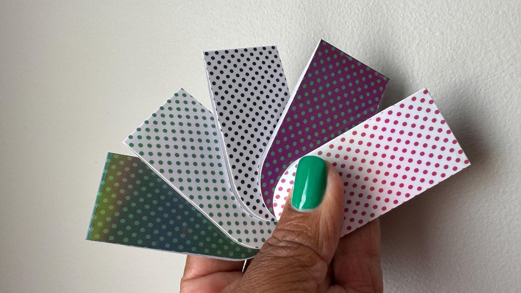 Holographic polka dot magnetic bookmarks featuring colorful, shiny designs for marking pages in books.