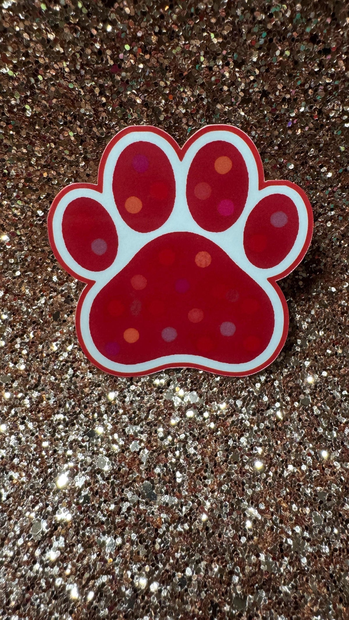 Colorful polka dot paw print vinyl sticker featuring a cute animal design, waterproof and durable pet lover gift accessory.