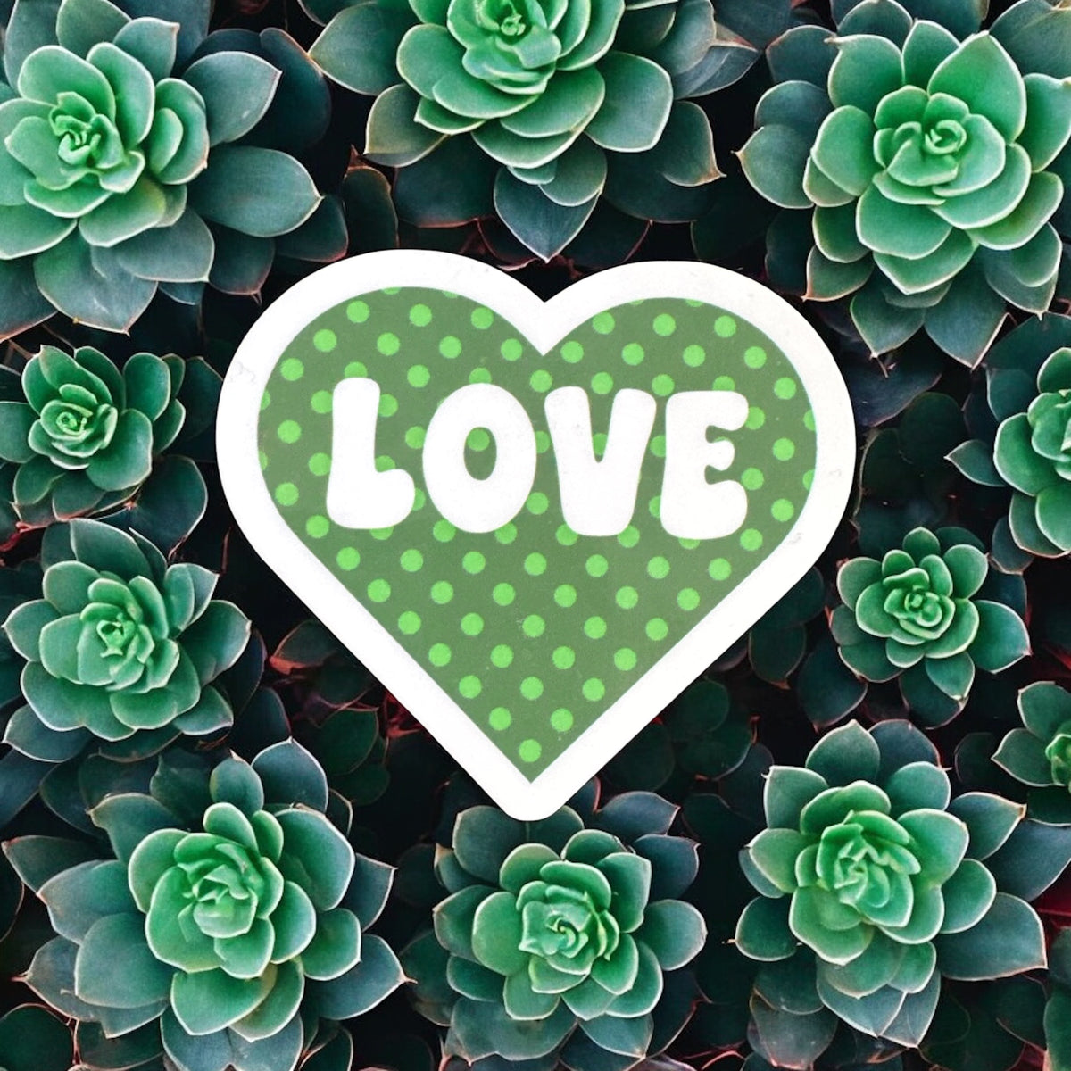 Retro polka dot love heart vinyl sticker by Forcebuilder, perfect for decorating journals, laptops, and personal items.