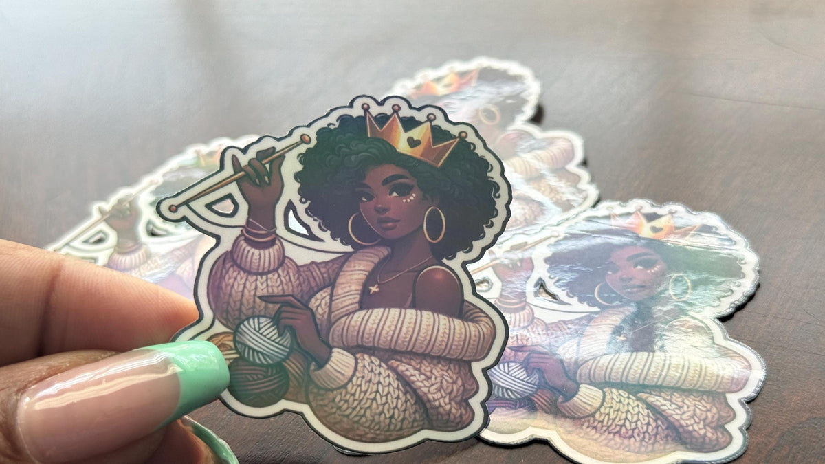 Crochet Queen sticker featuring a curly-haired woman with a crown, cozy vibes, waterproof vinyl finish, perfect for yarn lovers.