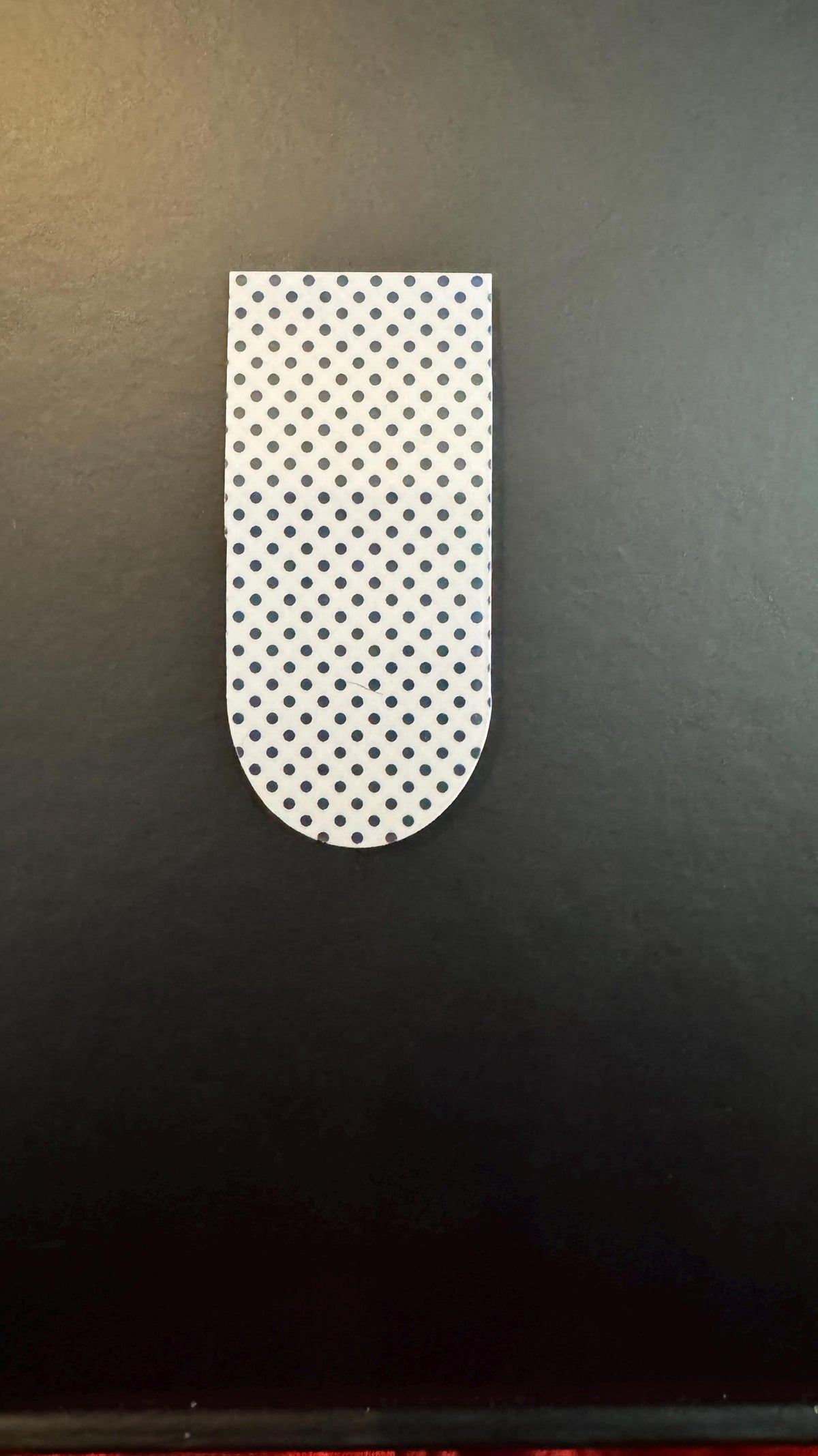 Holographic polka dot magnetic bookmarks featuring shiny, colorful designs for marking pages in books.