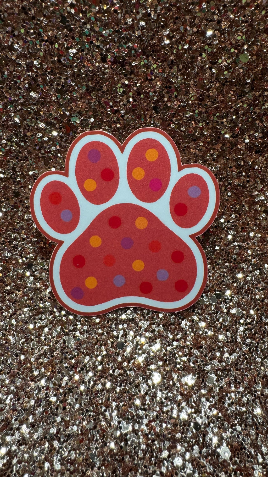 Colorful polka dot paw print sticker featuring cute animal design, waterproof and durable vinyl suitable for pet lovers.