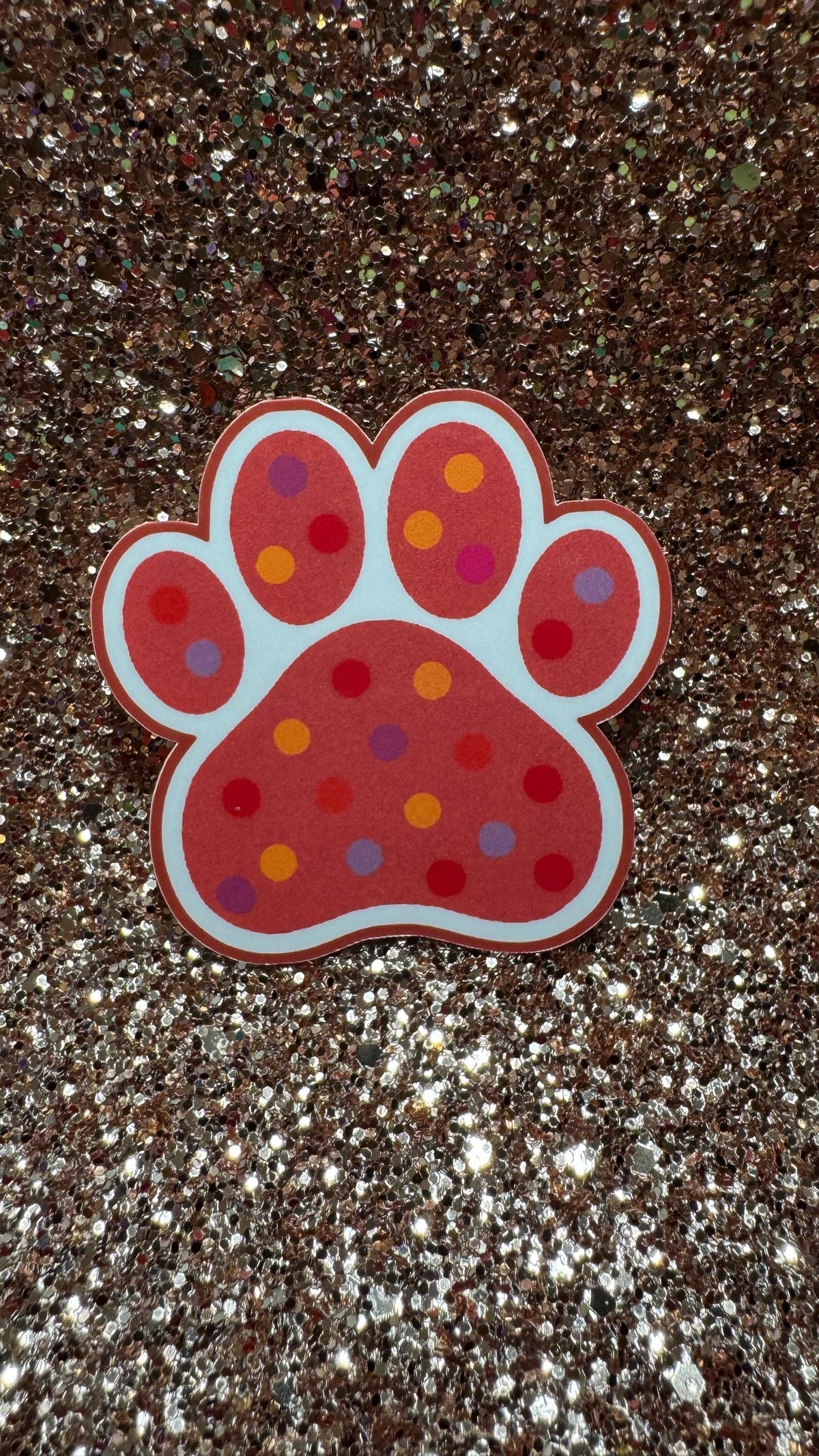 Colorful polka dot paw print sticker featuring cute animal design, waterproof and durable vinyl suitable for pet lovers.