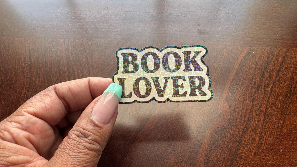 Holographic Book Lover sticker featuring a vinyl decal with book imagery, suitable for laptops, water bottles, and journals.