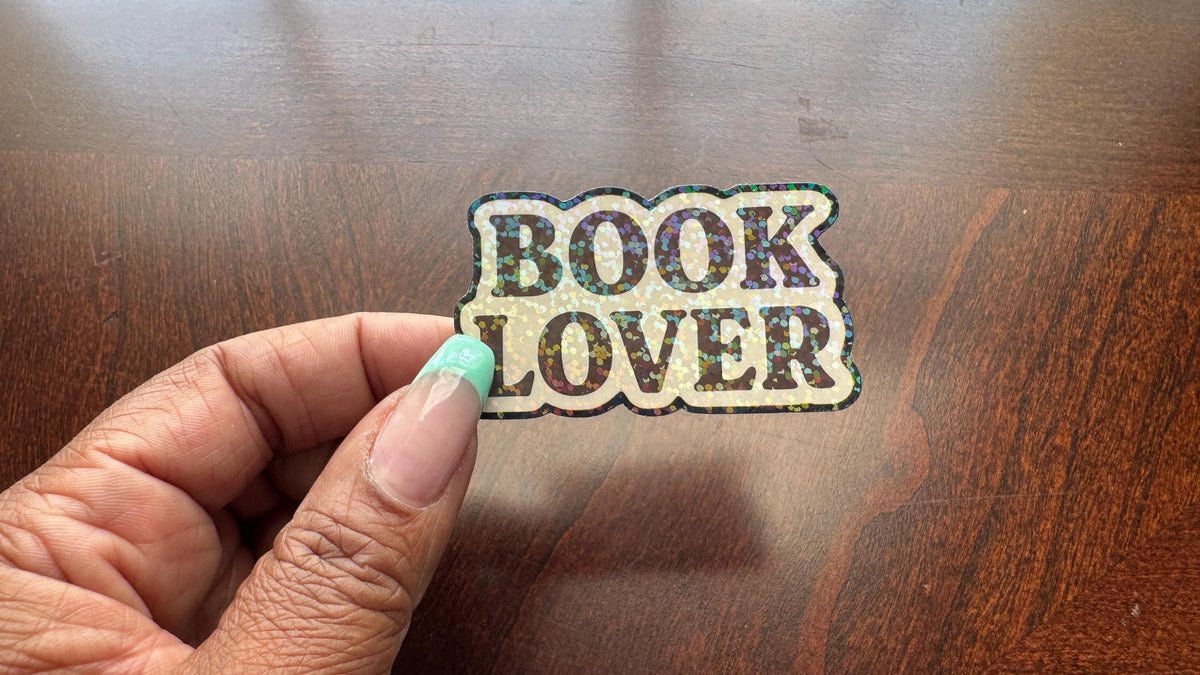 Holographic Book Lover sticker featuring a vinyl decal with book imagery, suitable for laptops, water bottles, and journals.