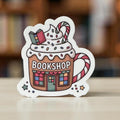 Forcebuilder Bookshop Holiday Mug Sticker featuring Christmas books, candy canes, whipped cream, perfect for cozy book lover decor