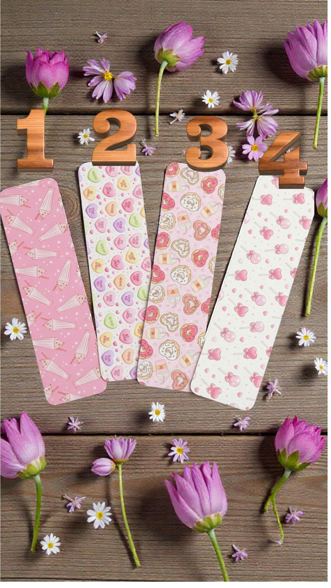Set of cute pink Valentine bookmarks featuring candy hearts and sweet treats, perfect reading accessories for book lovers.